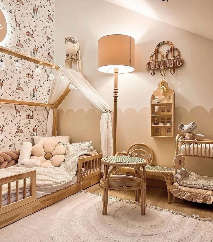 Cozy kids room with pastel pink walls and storybook-themed decals.