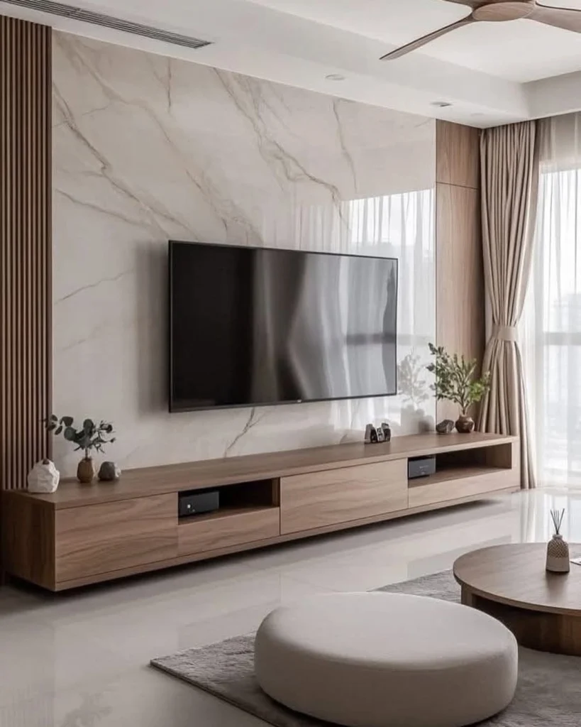 Geometric TV wall decor with bold hexagonal tiles and navy accents in a stylish space.