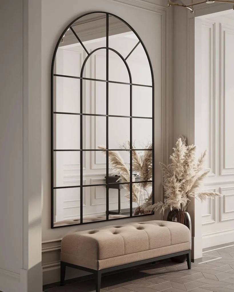 Framed botanical prints arranged in a serene bedroom.