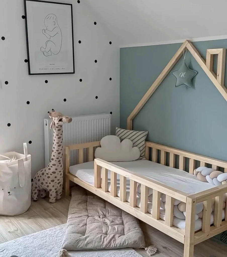 Enchanted forest kids room with tree mural and animal decor.